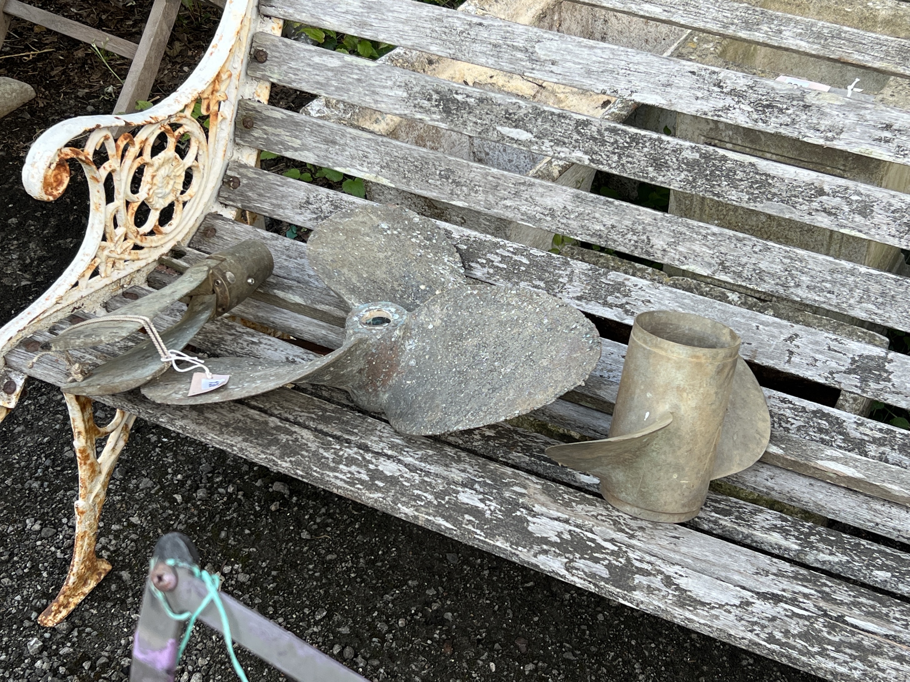 Two vintage brass ship's propellers and an oar rowlock, largest 42cm